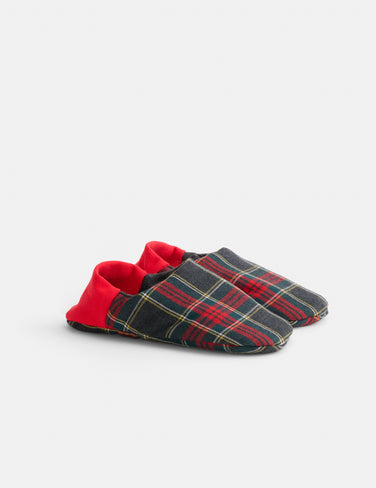 The Wool Plaid House Shoes are soft, machine washable slippers featuring a dark plaid pattern and vibrant red heel cuffs, showcased on a plain light background.