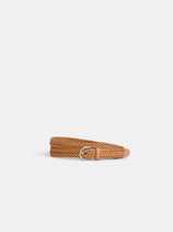 The Dragon Diffusion Woven Leather Belt, tan and braided with a silver D-ring buckle, is coiled neatly on a plain white background.