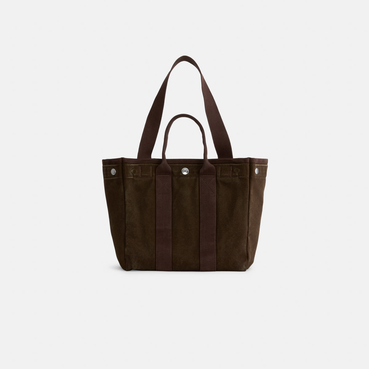 Introducing The Perfect Daily Tote: a dark brown suede bag with two short handles and a detachable long shoulder strap. This elegant tote features vertical accents and silver-tone hardware, photographed on a plain white background—an ideal choice for those seeking a stylish, monogrammable bag that blends everyday versatility with timeless sophistication.