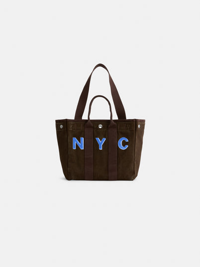 The Perfect Daily Tote is a brown cotton bag with two sturdy handles, showcasing bold blue “NYC” lettering on the front and set against a plain white background. Combining style and practicality, this personalized tote is ideal for everyday use.