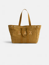 The Perfect Weekend Tote is a spacious brown cotton bag with two handles, silver button accents, and "LAX" stitched in white on the front—ideal as a personalized tote for daily use.
