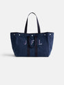 The Painted Perfect Weekend Tote is a spacious navy blue canvas bag with two handles, button accents on the top edge, and "JFL" embroidered in white and purple on the front.