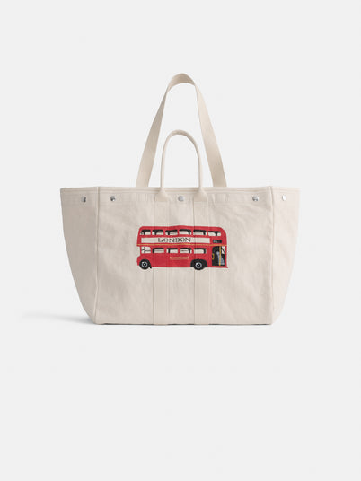 Introducing the Limited Edition Painted Perfect Weekend Double Decker Tote—a beige cotton bag with sturdy handles, adorned with a vibrant red London double-decker bus beautifully embroidered on the front. Spacious and stylish, this charming accessory is perfect for everyday use and makes an ideal tote for monogramming to add your own personalized touch.