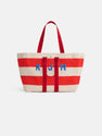The Perfect Striped Weekend Tote features wide red and off-white stripes, red handles, and blue "KJM" initials on the front.