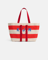 The Perfect Striped Weekend Tote features wide red and off-white stripes, red handles, and blue 