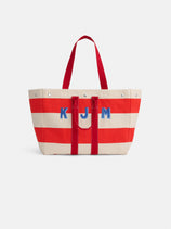 The Perfect Striped Weekend Tote features wide red and off-white stripes, red handles, and blue "KJM" initials on the front.