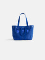 The Painted Perfect Weekday Tote in royal blue features two handles and bold white "NYC" embroidery on the front, shown against a simple white background.