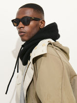 A man wearing black sunglasses, a khaki hooded jacket, and the Balaclava in Cashmere stands against a plain white background.
