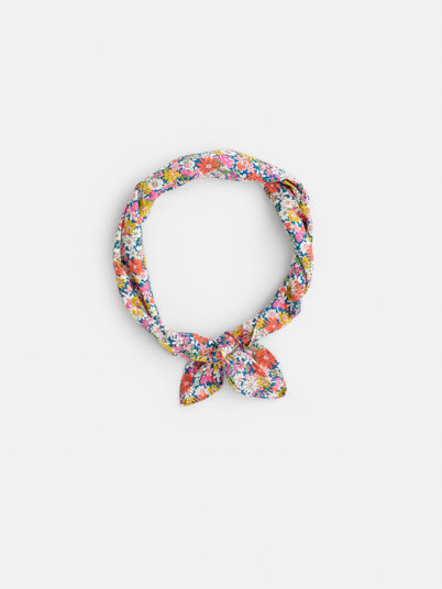 The Alex Mill x Liberty Bandana, featuring a colorful floral pattern from Liberty Fabric and tied in a loose knot, is displayed on a plain white background—a perfect summer accessory.