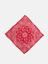 The Two Tone Bandana in Cotton is a vintage-style red square made in Italy, featuring white paisley and floral patterns on soft cotton voile, displayed flat against a plain light background.