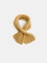 The Bedford Scarf in Cashmere, in a rich mustard yellow hue, is neatly arranged in a loop on a plain white background.