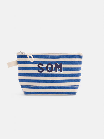 The Perfect Canvas Pouch in Stripe is a personalized bag with blue and white horizontal stripes, "SOM" initials in dark blue, a beige zipper, and a small beige fabric handle on the side.