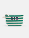 The Painted Perfect Striped Canvas Pouch features green and white horizontal stripes, a white zipper, and navy blue "SOM" lettering on the front.