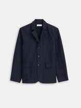 Mill Blazer In Vintage Twill by Alex Mill, a navy blue tailored cotton blazer with three front pockets and three buttons, is shown on a plain white background.