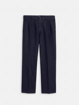 The Double Pleated Pant in Vintage Twill is a pair of dark navy blue men's cotton pants with a straight-leg fit, belt loops, button closure, and side pockets, shown laid flat on a plain white background.