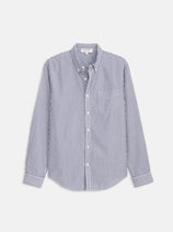 The Mill Shirt in Stripe Portuguese Poplin is a lightweight men’s cotton shirt with blue and white vertical stripes, a button-down collar, and chest pocket, crafted from premium Portuguese cotton.