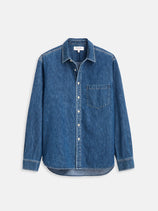 The Easy Shirt In Denim is a blue vintage-inspired denim shirt featuring a relaxed fit, long sleeves, button-up front, and a single chest pocket, shown laid flat on a white background.