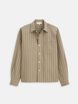 The Franklin St Striped Shirt In Cotton is a men's oversized beige shirt in heavy weight poplin with thin black stripes, front chest pocket, and buttoned cuffs. The button down style is shown laid flat on a white background.