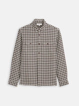 The Mill Double Gauze Shirt In Cotton Plaid by Alex Mill features 100% cotton fabric, long sleeves, a brown/white/black plaid pattern, and two button-flap chest pockets, shown laid flat on a white background.