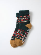 RoToTo Snowflake Room Socks, made in Japan, feature folded green cuffs, brown heels and toes, and a festive pattern in green, red, cream, and brown with decorative shapes like hearts and zigzags.