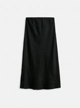 The Claire Skirt is a long, black, high-waisted women's designer skirt with a subtle crinkled texture, shown flat against a white background.
