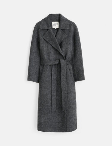 The Georgia Wrap Coat in Wool Alpaca is a long, dark gray coat featuring a wide lapel collar, long sleeves, and a matching belt at the waist. This elegant overcoat is shown on a white background.