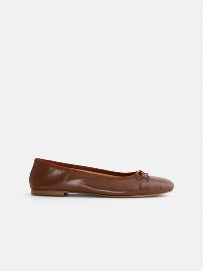 The Prince Street Ballet Flat features brown Italian leather, a rounded toe, small front bow, and low wooden heel, photographed on a plain white background.