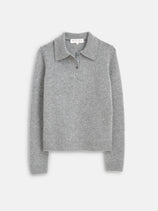 The Alice Polo In Cashmere is a light gray, long-sleeve sweater featuring ribbed cuffs and hem, a classic collar, and a three-button placket. The soft sweater is displayed flat on a plain white background.