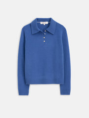 The Alice Polo In Cashmere is a royal blue, long-sleeve sweater with a classic collar and four buttons at the neckline, displayed on a plain white background.