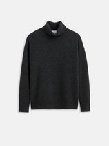 The Maisie Turtleneck Sweater in Cashmere, a dark grey women’s designer piece, is shown flat on a white background. This luxurious long-sleeve sweater has a loose fit with ribbed cuffs, hem, and collar.