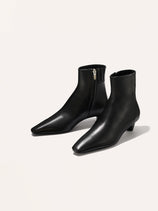 The Alex Mill x Margaux: The Inga - Black Calf boots are made from Italian black calf leather with pointed toes, low kitten heels, and side zippers, shown against a plain white background.